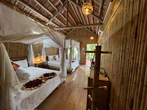 a bedroom with a bed and a cross on the floor at Tam Coc Horizon Bungalow in Ninh Binh