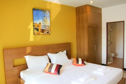 a bedroom with a large white bed with two pillows at Krabi Cinta House in Krabi town