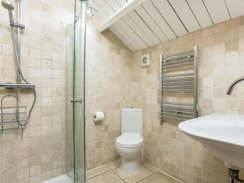 a bathroom with a toilet and a sink at Campden Barn in Chipping Campden