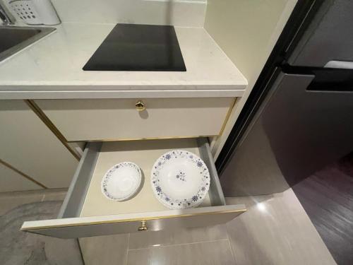 a counter with two plates in a drawer at Grand Florida pattaya by waranya in Na Jomtien