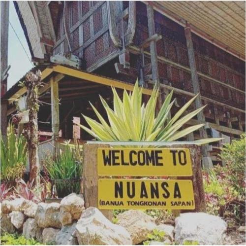 a yellow welcome to namines sign in front of a house at NUANSA HOMESTAY Authentic&Hospitality in Rantepao