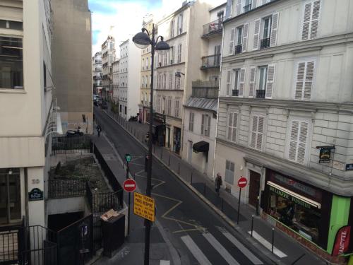 a city street with buildings and a street light at Hotel Marena in Paris