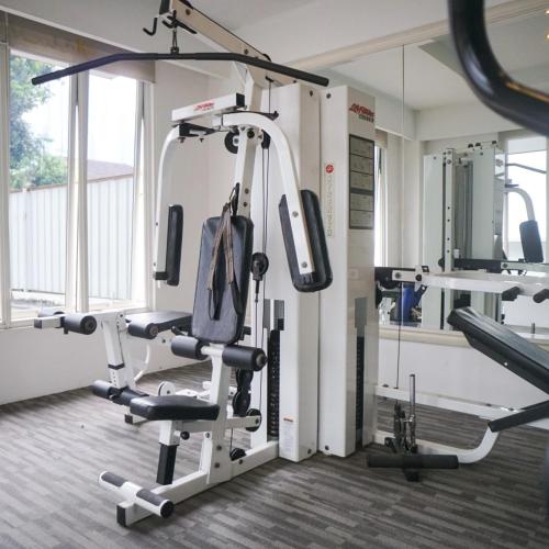 a room with a gym with a treadmill at Lemansion Senopati in Jakarta