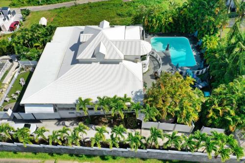 an aerial view of a resort with a swimming pool at GREEN LORD DOMAINE - Lodges Piscine & Spa - Bar & Lounge - Restaurant gastronomique in Lamentin