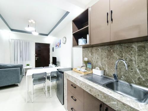 a kitchen with a sink and a counter top at Manzil Anilao B&B in Mabini