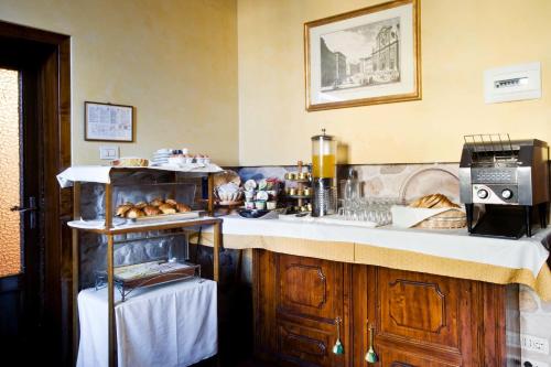 a kitchen with a refrigerator, sink, and dishwasher at Hotel Alessandra in Florence