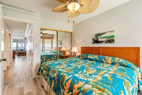 a bedroom with a bed and a ceiling fan at The Sea Village #1302 in Kailua-Kona
