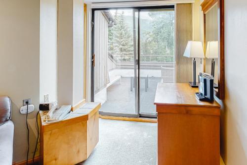 a room with a desk with a computer and a window at Aspen Mountain Lodge 401 in Aspen