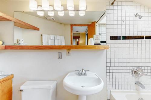 a bathroom with a sink and a toilet and a mirror at Aspen Mountain Lodge 401 in Aspen