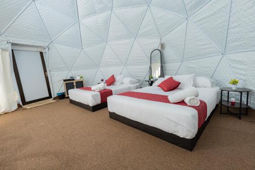 a room with two beds in a tent at Glamz Hills in Cameron Highlands