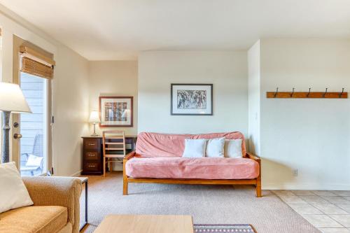 a living room with a couch and a table at Tree Top Retreat in Bend