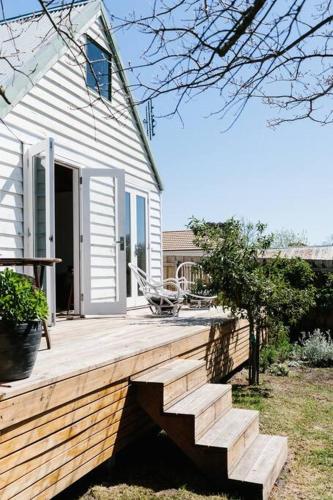 a wooden deck with stairs leading to a house at Harpsichord House in Kyneton