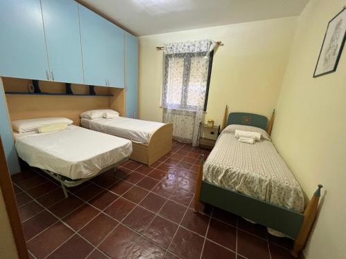 a room with two beds and a window at La casa di Clelia in Cercola