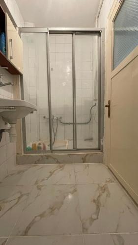 a bathroom with a glass shower and a sink at Private room in old city in Istanbul