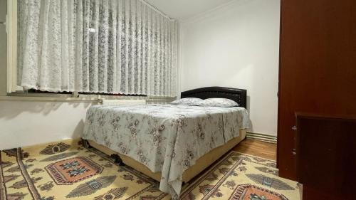 a bedroom with a bed and a window and a rug at Private room in old city in Istanbul