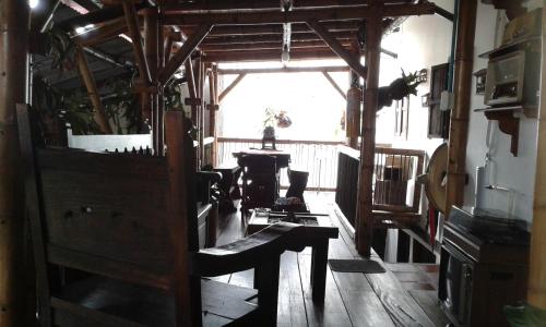 an old room with a wooden floor and a window at Hostel Camelot Salento in Salento