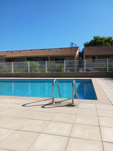 une piscine devant un immeuble dans l'établissement Chez Yamina, à Gruissan