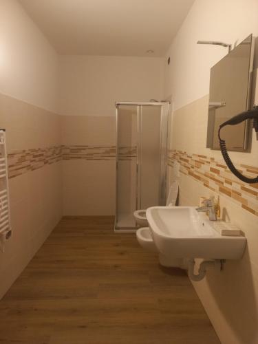 a bathroom with two toilets and a sink and a shower at Gardafarm agriturismo in Verona