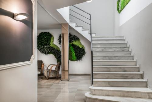 a staircase with green plants on the wall at Hotel Sansi Park in Lleida