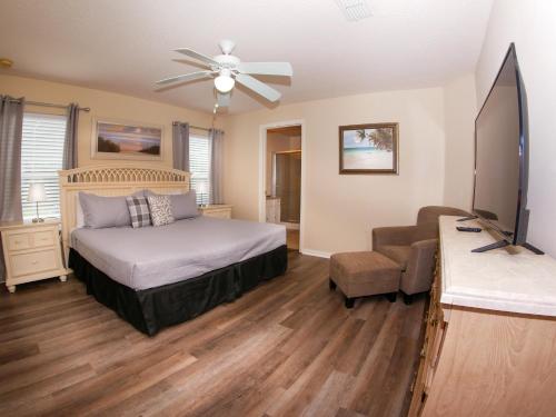 a bedroom with a bed and a flat screen tv at Great Community, Amazing Private Pool, Near Disney! in Davenport