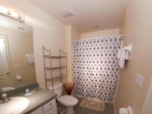 a bathroom with a toilet and a sink and a shower at Great Community, Amazing Private Pool, Near Disney! in Davenport