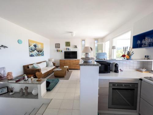 a kitchen and living room with white counter tops at Valentina panoramic seaside house in Capitana