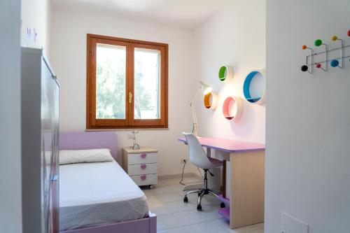 a bedroom with a desk and a bed and a desk with a chair at Valentina panoramic seaside house in Capitana