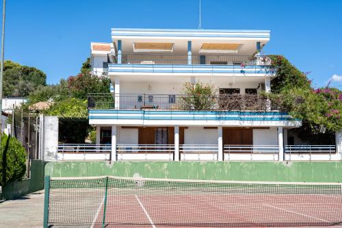 a tennis court in front of a building at Valentina panoramic seaside house in Capitana