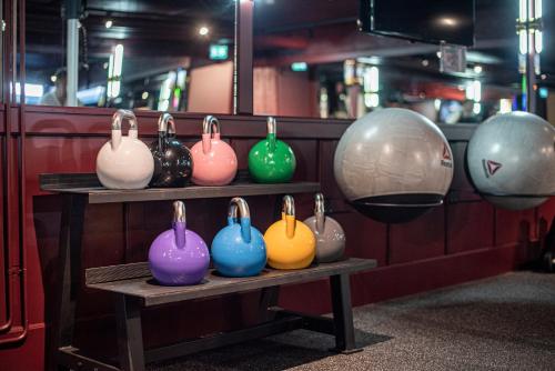 a group of different colored vases on a shelf at Statt Hassleholm BW Signature Collection in Hässleholm