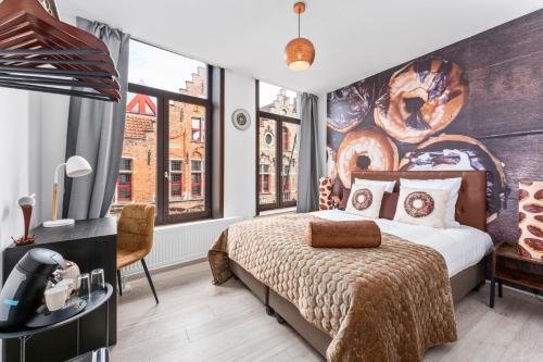 a bedroom with a bed and a large mural on the wall at The Chocolate Suites in Bruges