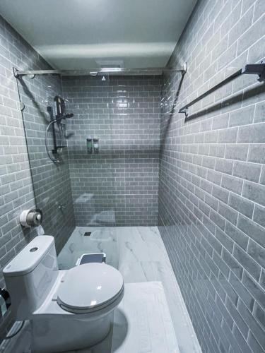 a bathroom with a white toilet and a shower at Yamee Homestay Cafe in Ban Pha Mi