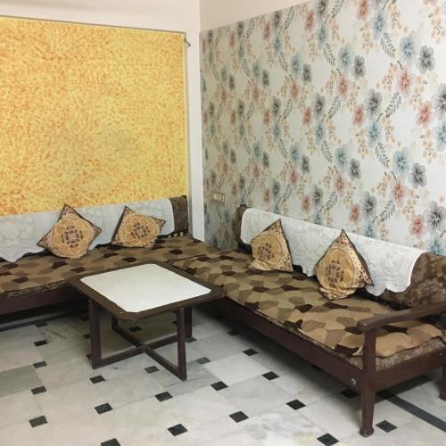 a living room with a couch and a table at Lexus home in Ahmedabad