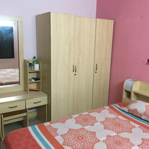 a bedroom with a bed and a dresser and a mirror at Lexus home in Ahmedabad