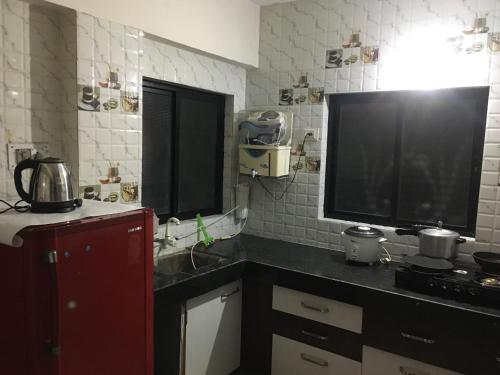a kitchen with a tv on a counter with a counter sidx sidx sidx at Lexus home in Ahmedabad