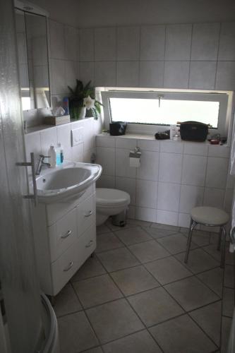 a bathroom with a sink and a toilet at Haus Seesand Wittdün in Wittdün