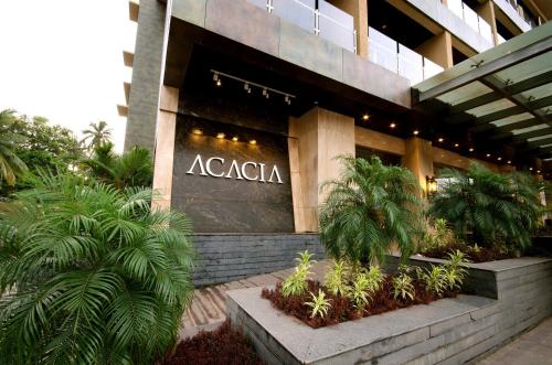aania sign on the front of a building at The Acacia Hotel & Spa in Candolim