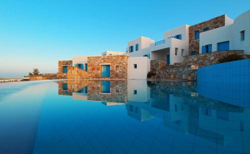a view of a building with its reflection in the water at Miramare Hotel in Chora Folegandros