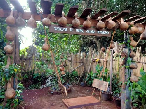a garden with a sign that reads welcome to fresh wine infusion at Tribal Village Homestay & Trekking in Banlung