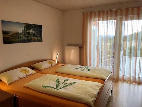 two twin beds in a room with a window at Haus Ketterer in Bad Dürrheim