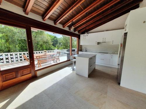 a kitchen with white cabinets and a large window at Dreams and friends on the coast of Bilbao. in Getxo