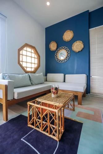 a living room with a couch and a table at Wayla Villa@Maikhaobeach in Mai Khao Beach