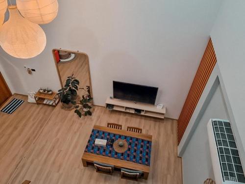 an overhead view of a living room with a tv at Wayla Villa@Maikhaobeach in Mai Khao Beach