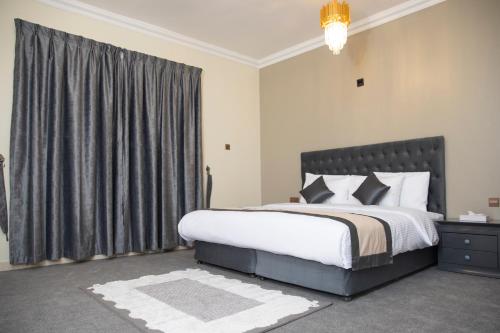 a bedroom with a large bed and a window at Sea Shore Hotel Apartment Khorfakkan in Khor Fakkan