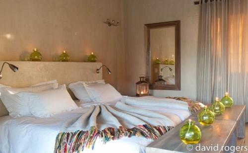 a bedroom with a large bed and a mirror at Emanya@Etosha in Namutoni