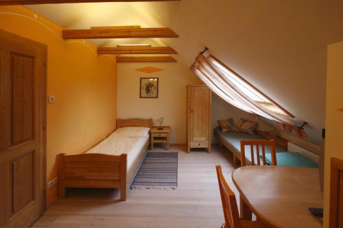 a bedroom with a bed and a table and a couch at Pension Wenger in Kirchheim im Innkreis