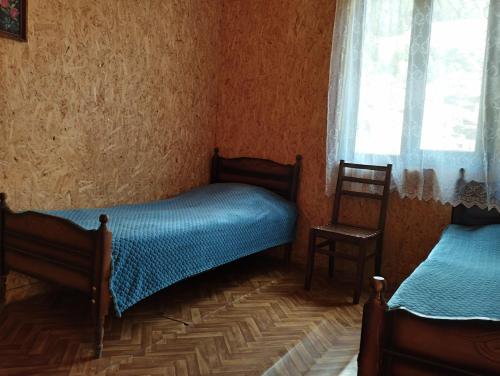 a bedroom with two twin beds and a window at Makratela in Akhmety