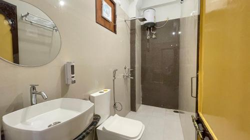 a bathroom with a toilet and a sink and a shower at PETAL OF MEWAR - A Luxury Boutique Hotel in Udaipur