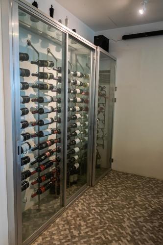 a walk in wine cellar with a rack of wine bottles at GIARDINO ROMANTICO in Dumaguete