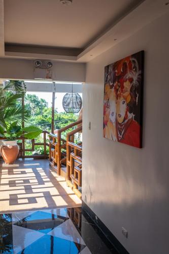 a room with a painting on the wall and a glass floor at GIARDINO ROMANTICO in Dumaguete