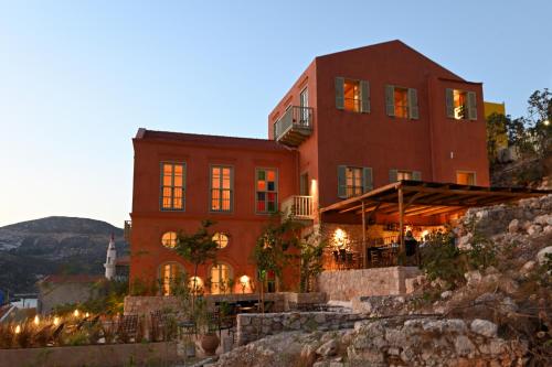 a house on a hill with lights in front of it at Casa Mediterraneo Hotel in Meyisti